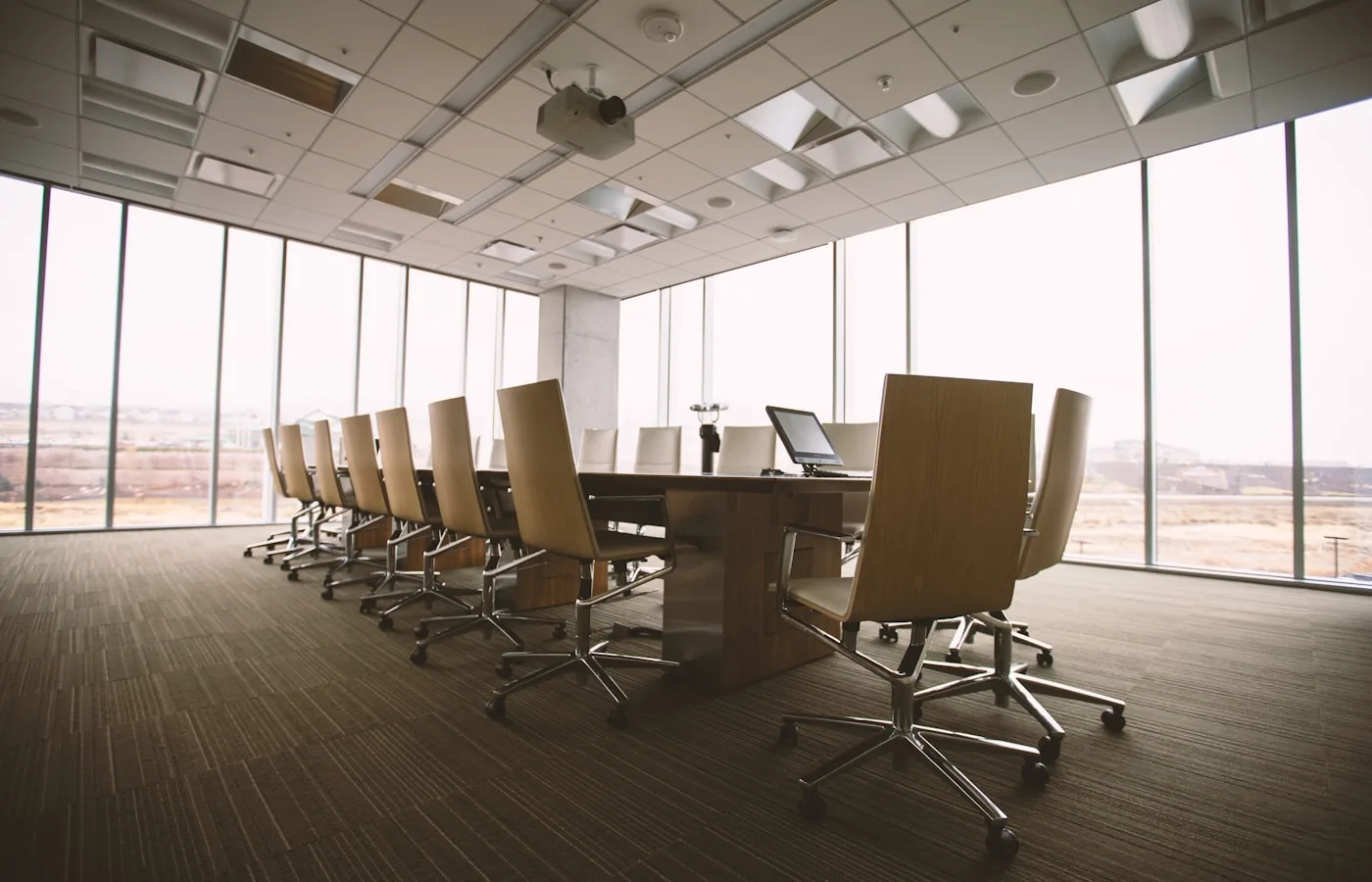 Formal boardroom with long conference table and chairs