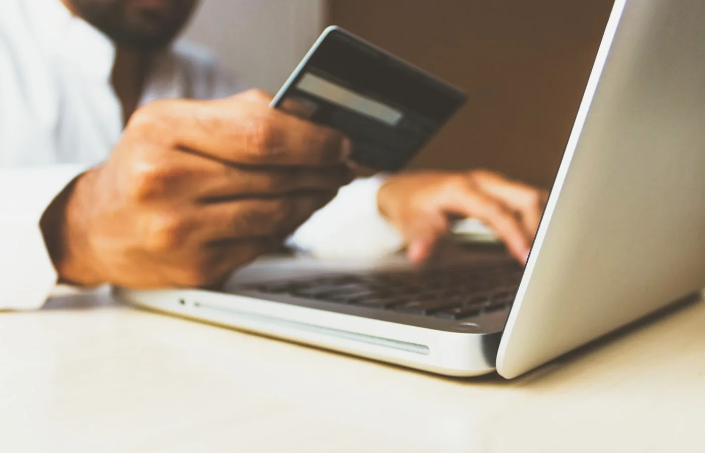 Person completing a financial transaction on laptop